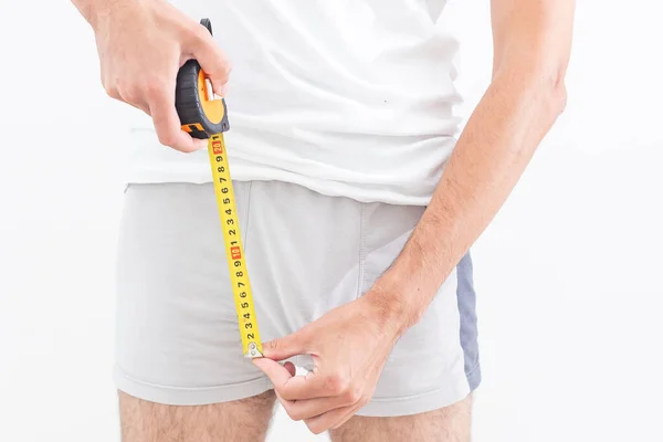 Man Questioningly Holds Measuring Tape His Underpants — Stockfoto