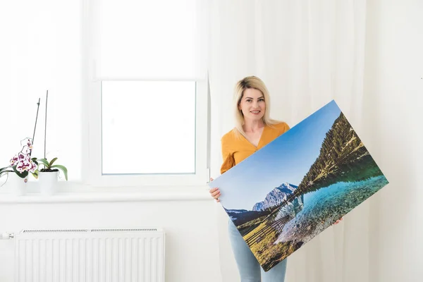 Canvas prints. woman holding photo canvas.