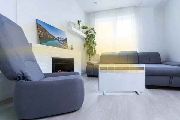 Modern electric infrared heater in living room.