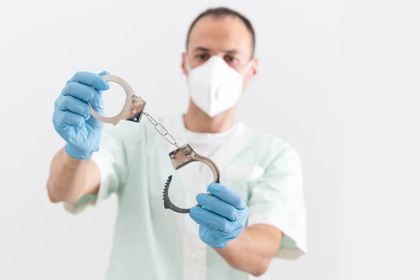 Corona virus prevention face masks at home. Hands in handcuffs medical respiratory bandage face on white background.