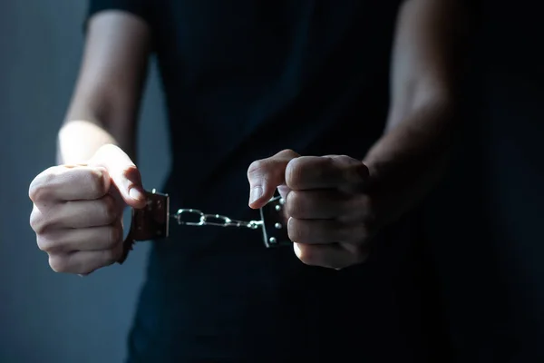 prisoner concept, Handcuffed hands of a prisoner in prison, Male prisoners were severely strained in the dark prison, violence