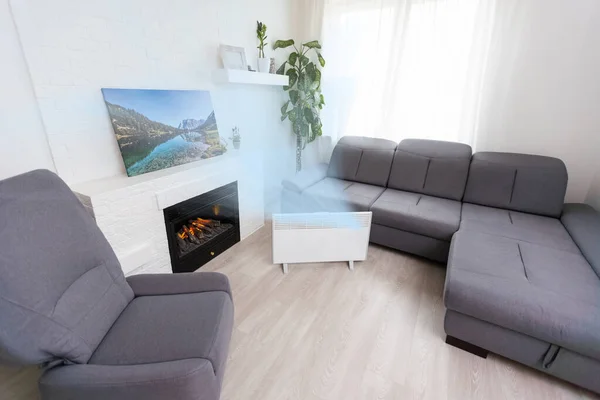 Modern electric infrared heater in living room.