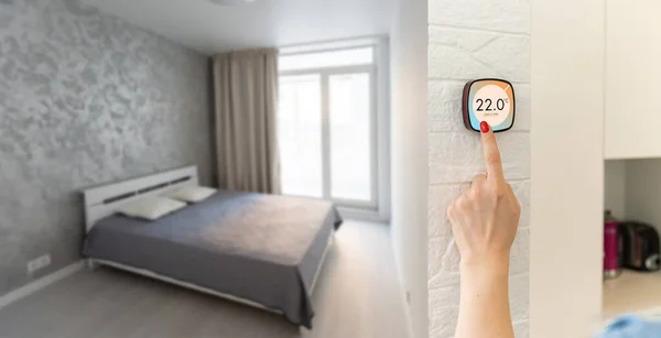 Controlling home heating temperature with a smart home, close-up on phone. Concept of a smart home and mobile application for managing smart devices at home. High quality photo