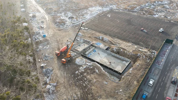 Drones aerial photo of a construction site of a pool, formwork concrete blocks already finished and bricked up with construction adhesive, steps already prepared and ready for concrete filling