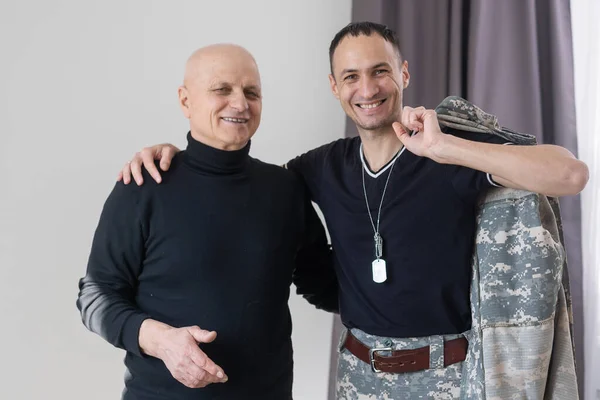 Portrait of army man with parents, elderly father and military son