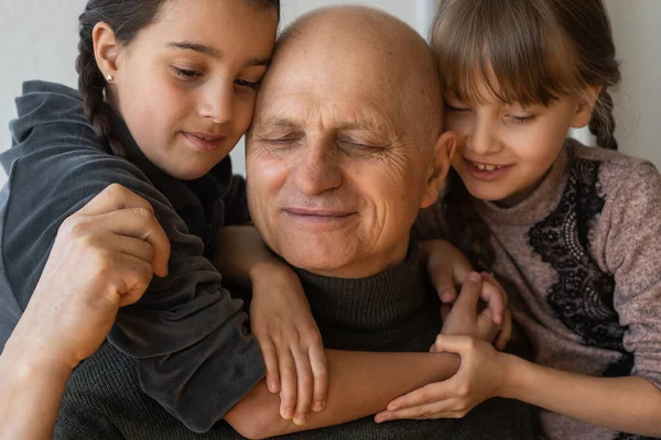 Grandfather Two Granddaughters Hugging Sofa Home — Stock Photo, Image