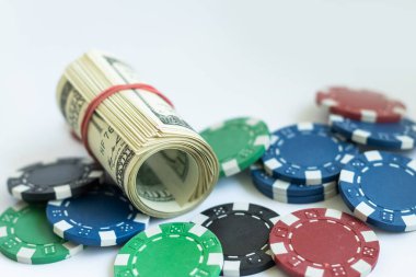 Beyaz arka planda parası olan poker çipleri yığını, USD para birimi.