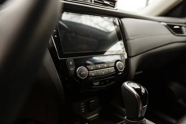 Modern car interior with dashboard and multimedia.
