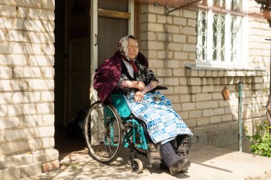 Old woman sitting in a wheelchair looking sad and worried. depression, healthcare and caring for the elderly.