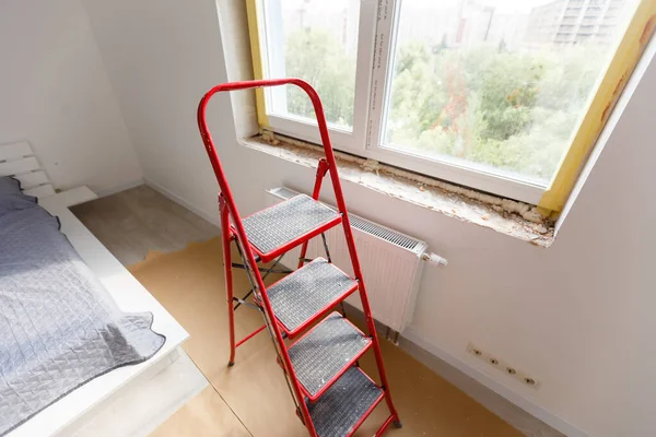 Installation of windows. Polyurethane foam on the slope of the window. Sealing window slopes