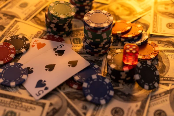 Poker cards royal flush, cash money dollar bills. Gambling, casino chips, dices. Casino tokens, gaming chips, checks, or cheques on green table in casino club.