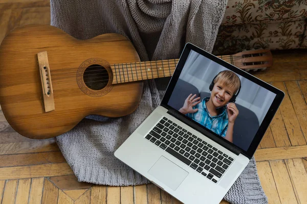 Cute Blond Boy Headphones Plays Guitar Looks Laptop Fun Online — 스톡 사진