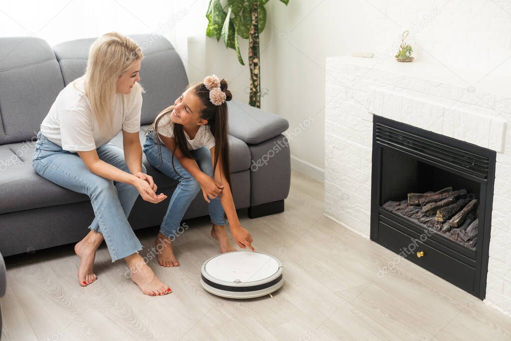 daughter and mother, robot vacuum cleaner, smart home technology.