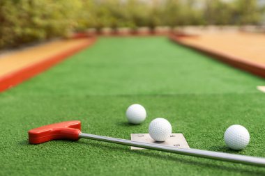 Yapay çimlerin üzerinde mini golf topu. Yaz sezonu oyunu.