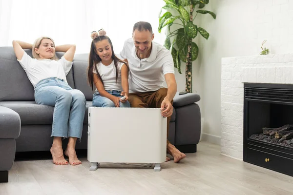 Electric Heater Home Young Family Warms Heating Radiator —  Fotos de Stock