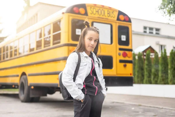 Child going back to school. Start of new school year after summer vacation. Little girl with backpack and books on first school day. Beginning of class.