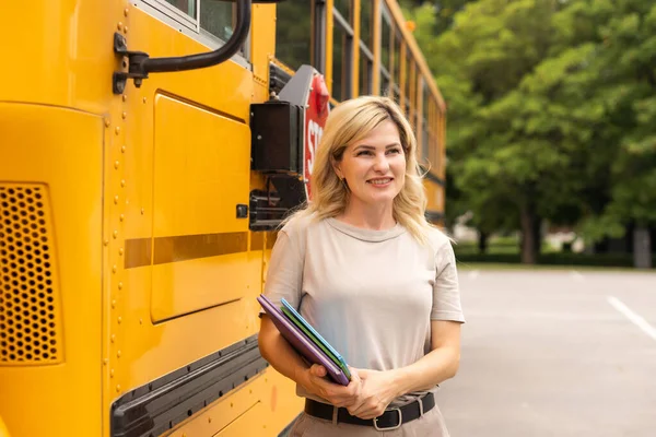 a woman near a school bus.