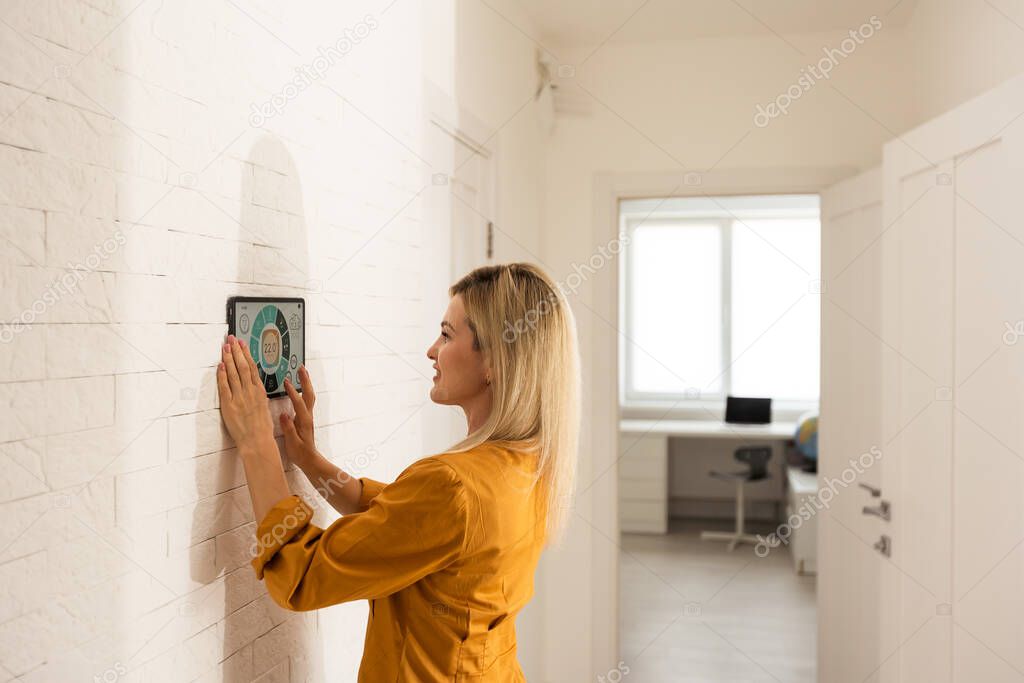 Woman at home using smart screen, automation domestic system