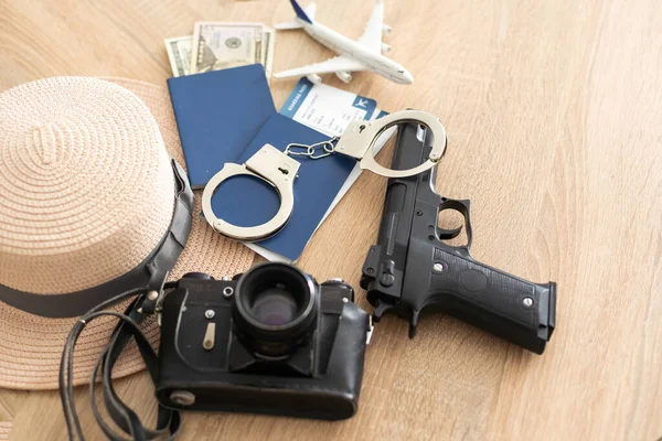 Travel and vacation concept, passport, money and gun on wood top table