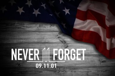 911 We will Never Forget text message with USA flag on wooden background. High quality photo
