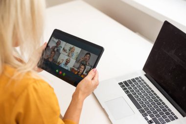 Smiling millennial woman using modern gadget, chat on tablet device, technology concept.