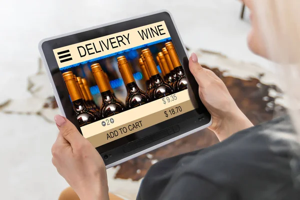 hands holding digital tablet with app delivery food wine screen