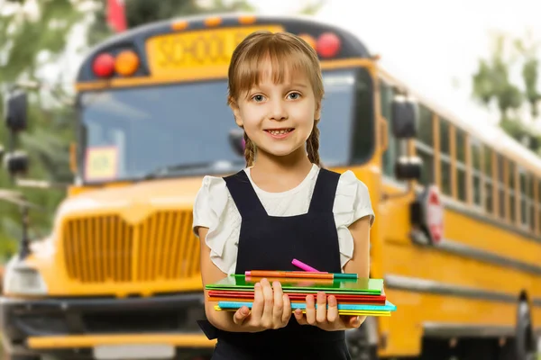 Smiling active excellent best student schoolgirl holding books and going to school wearing bag.