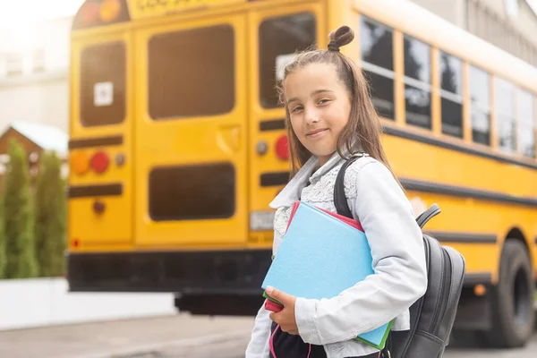 Child going back to school. Start of new school year after summer vacation. Little girl with backpack and books on first school day. Beginning of class.