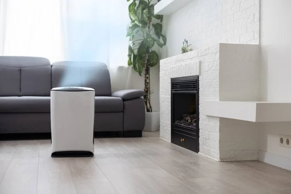 Air purifier in cozy white living room for filter and cleaning removing dust PM2.5 HEPA and virus in home, for fresh air and healthy Wellness life, Air Pollution Concept.