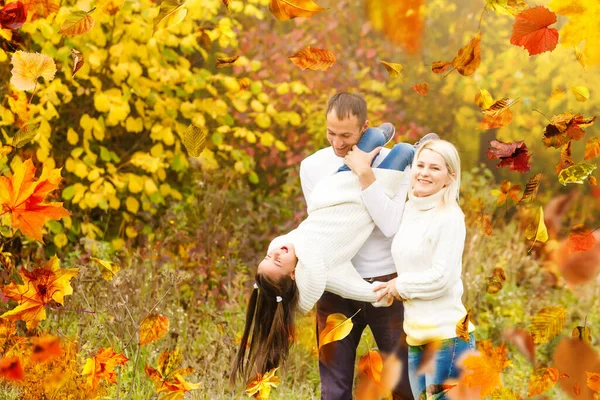 Family playing in autumn park having fun. High quality photo