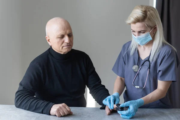 elderly man and nurse measuring pulse oximeter.