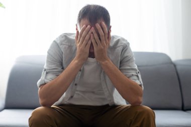 Exhausted Caucasian millennial male worker take off glasses massage eyes suffer from headache or migraine, tired man feel fatigue overwhelmed with computer work having blurry vision or sight problem