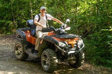 man quad bike in the forest.