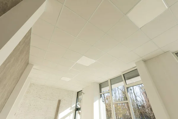 Hanging white styrofoam tiled ceiling.