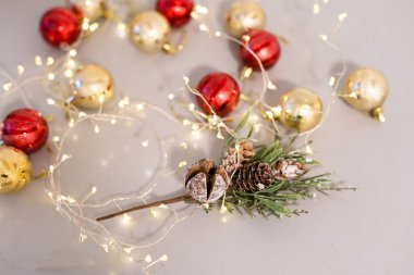 Red christmas ornaments on white background with xmas tree, twinkle bokeh lights. Merry christmas card. Winter holiday xmas theme. Happy New Year. Space for text.