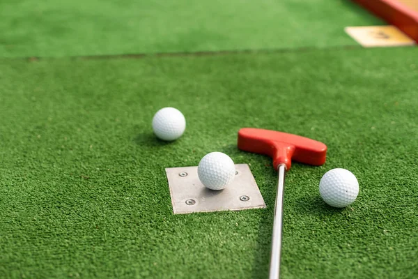 Assorted Miniature Golf Putters Balls Askew Synthetic Grass — 스톡 사진