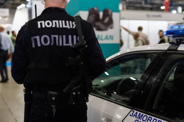 Police car lights close up. A policemen on the background
