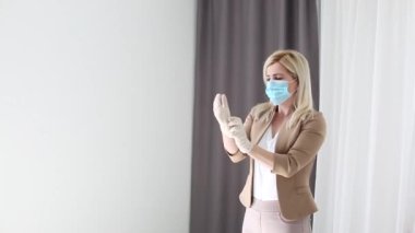 Woman in mask wear medical gloves for work. Health care medicine concept