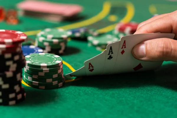 man playing blackjack at the table and betting chips.
