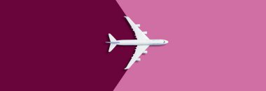 Flat lay of miniature toy airplane on purple background. High quality photo