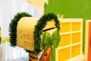 Christmas letter box to Santa with Christmas tree in the background.