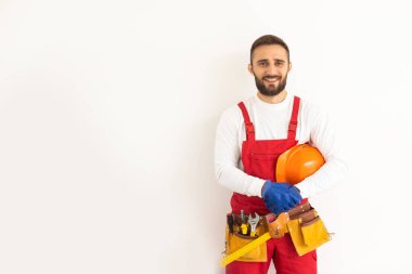 Male worker in a uniform posing isolated on white background.
