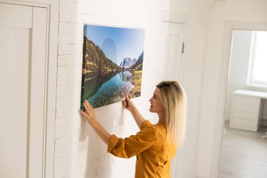 Young woman in yellow blouse hold canvas. Minimal art concept