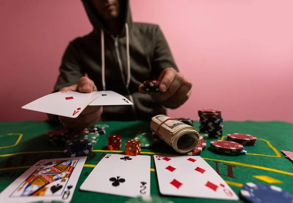 Happy poker player winning and holding cards