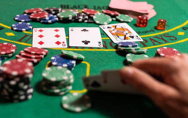 Player peeking cards in Blackjack game.