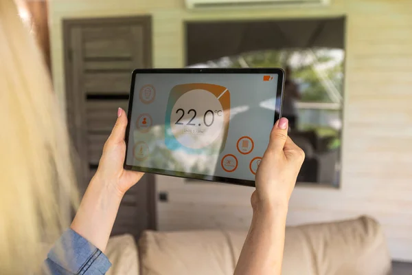 Modern home smart automation app on tablet display in woman hands