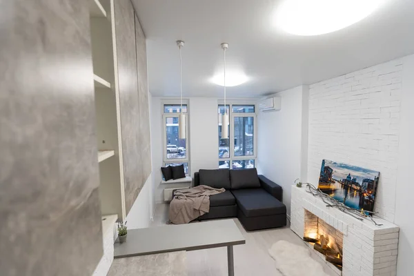 Modern studio flat with small kitchen, sofa