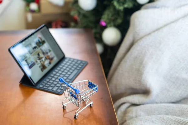 The concept online shopping. Laptop and small shopping cart. Christmas Sales. Fast delivery. Gifts when ordering.