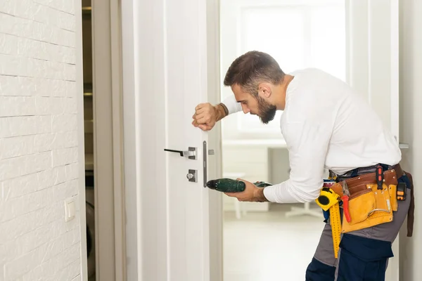 Good Looking Man Working Handyman Fixing Door Lock House Entrance — стоковое фото