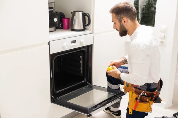 Repairman Examining Oven Screwdriver Kitchen Tool Case — Stock Fotó